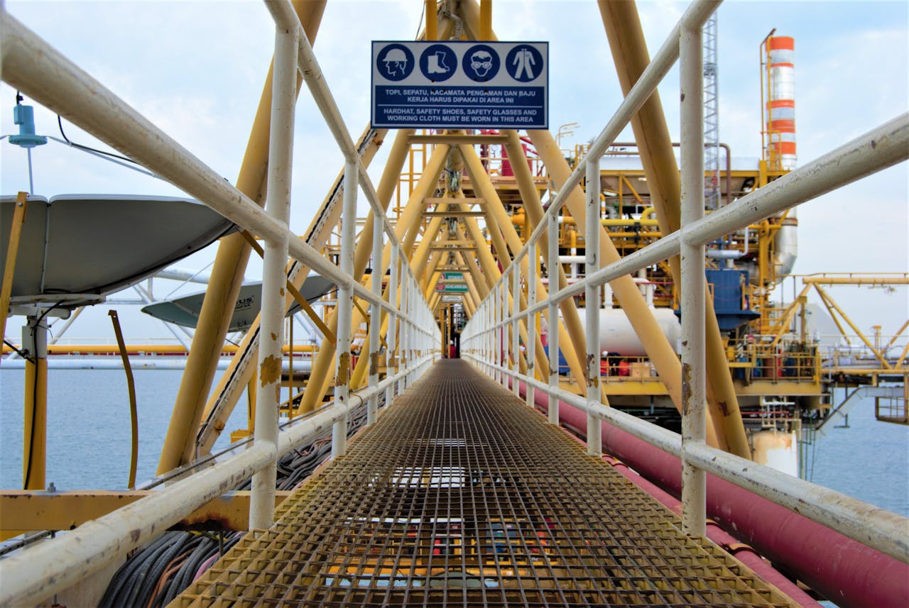 contact-img A steel walkway leading to an offshore oil platform in Indonesia, showcasing industrial architecture.