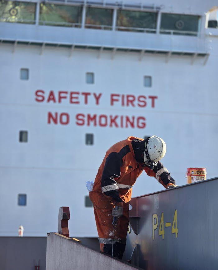 Crafting Captivating Headlines: Your awesome post title goes here Ship worker performing maintenance under safety guidelines in Mozambique.