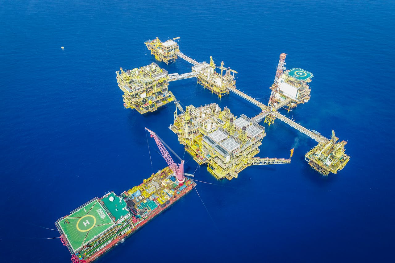 services-04 Aerial shot of an offshore oil platform complex in the ocean, showcasing industrial infrastructure.